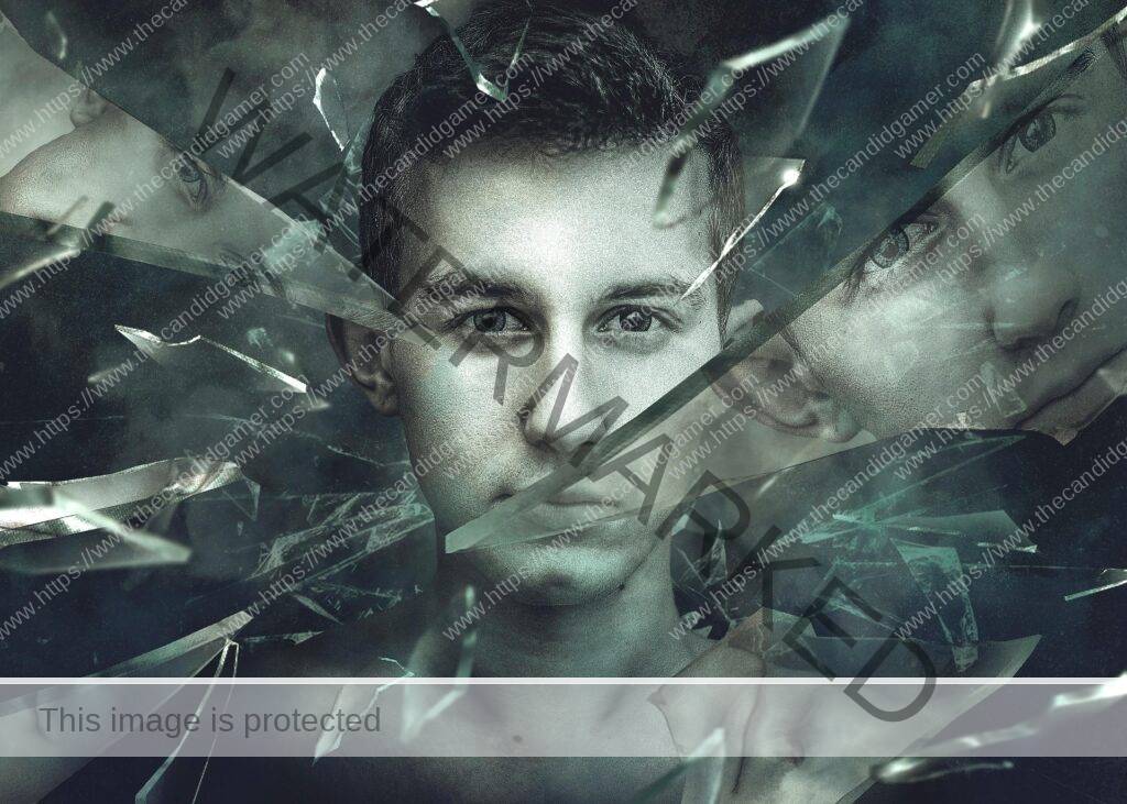 An image of a man, with shattered glass around him. His reflection can be seen in some of the glass fragments.
