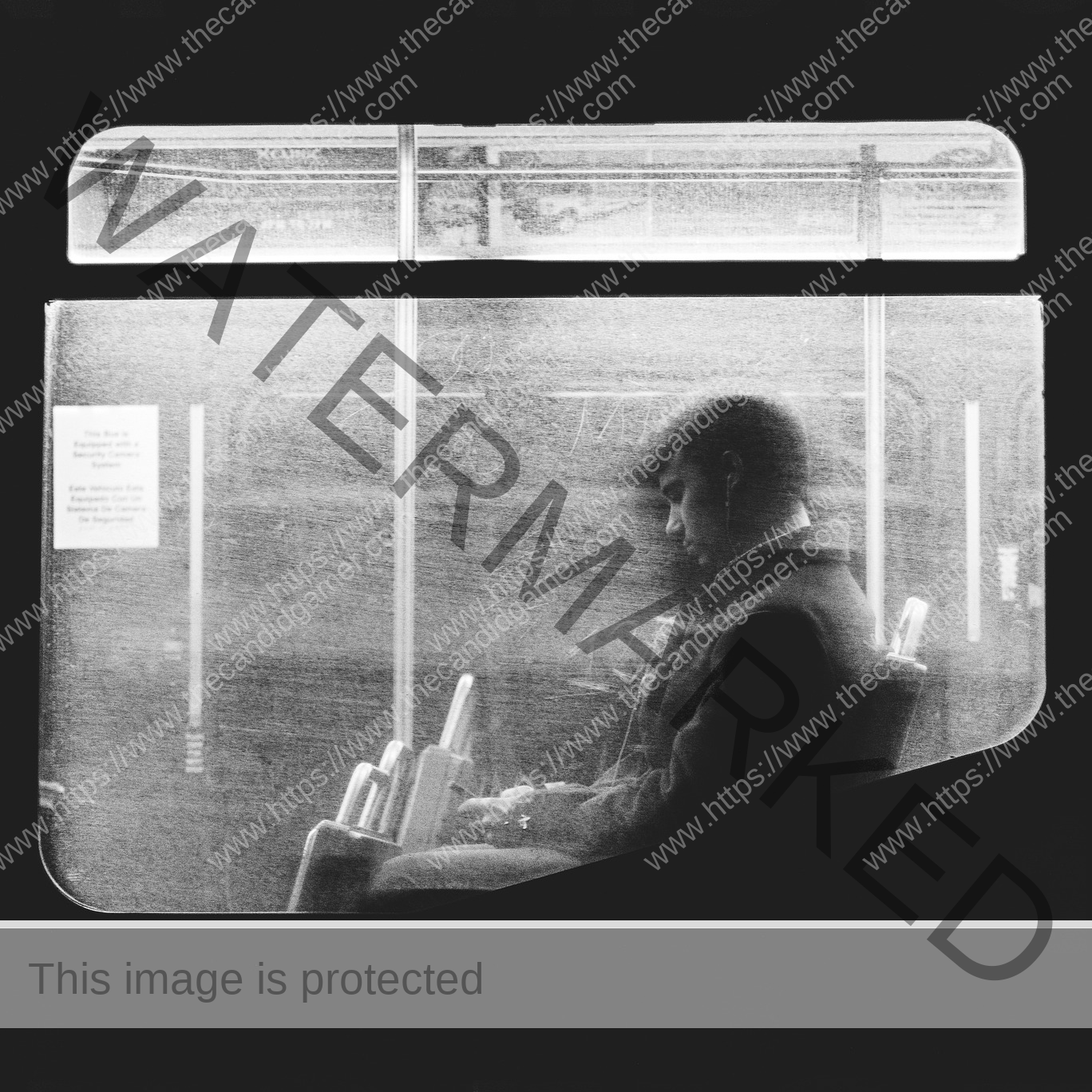 A man sits alone in a train, holding a phone.